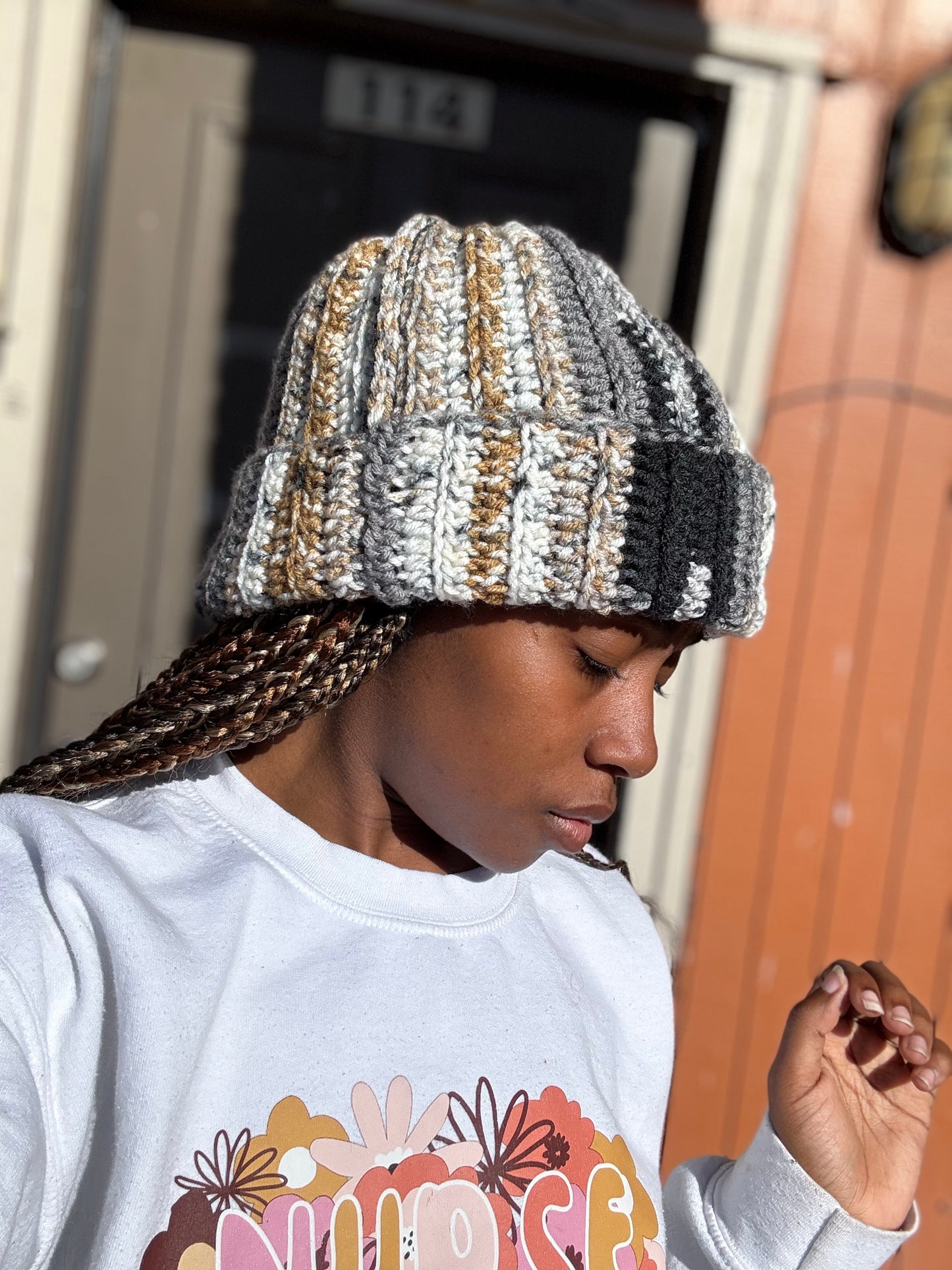 Woman wearing handmade crochet beanie in warm neutral tones – cozy winter hat by Hartfelt Crochet