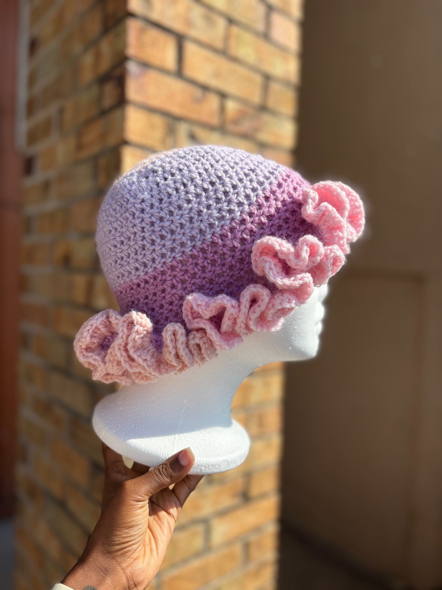 Handmade pink and lavender crochet ruffle brim hat on mannequin – Hartfelt Crochet
