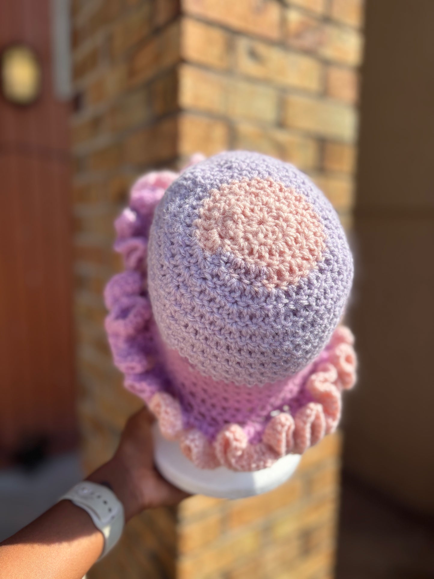 Handmade pink and lavender crochet ruffle brim hat on mannequin – Hartfelt Crochet